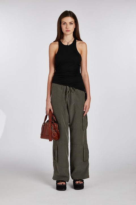 Chic and elegant black racerback tank top with an asymmetric hem. Made from soft, stretchy, and sustainable fabric for a comfortable and versatile fit.
