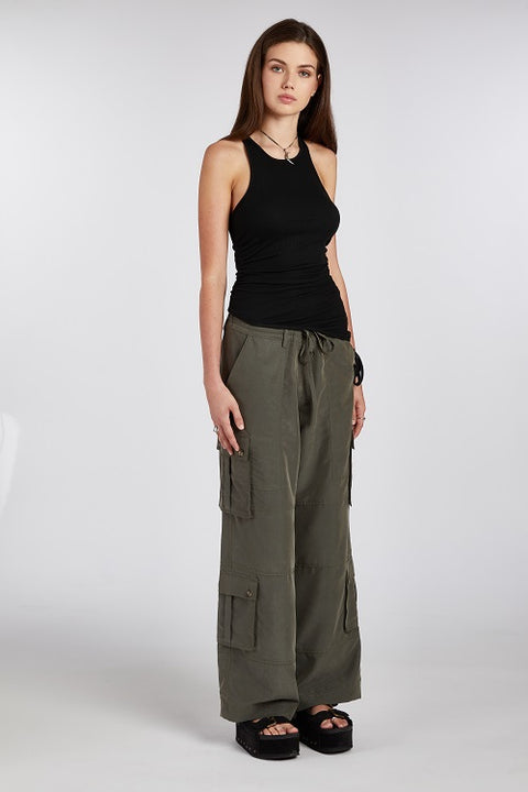 Chic and elegant black racerback tank top with an asymmetric hem. Made from soft, stretchy, and sustainable fabric for a comfortable and versatile fit.