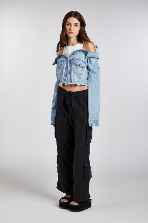 Contemporary off-shoulder denim jacket with a built-in white ribbed racerback tank top—an effortlessly cool 2-in-1 design. Crafted from premium Italian denim in a beautiful light wash, this slouchy yet elegant piece blends relaxed styling with a subtle edge. The unique silhouette offers a modern, wearable statement that transitions seamlessly from day to night.