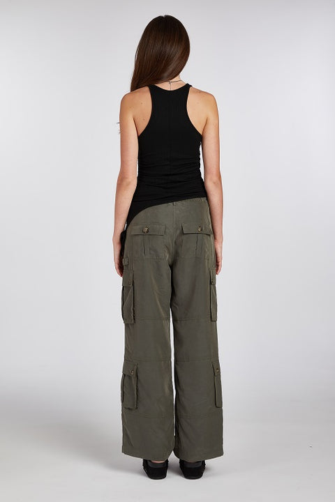 Back view of a versatile, chic and elegant black racerback tank top with a flattering asymmetric hem. Made from soft, stretchy, and sustainable fabric for a comfortable fit.